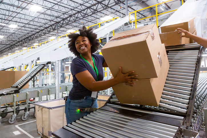 warehouse worker lifting boxes